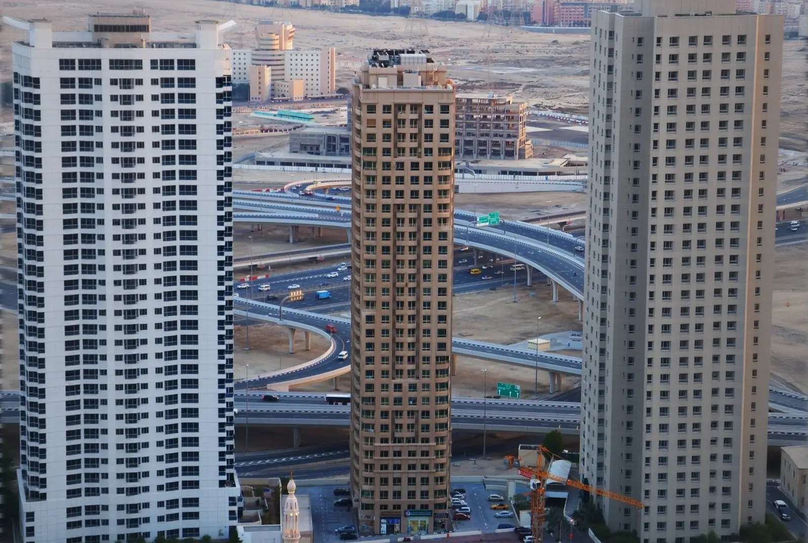 Residential towers beside a road shown in the MANCHESTER PROPERTIES "Manchester Tower" catalogue, Dubai